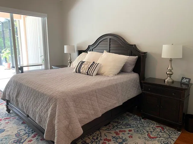 a bedroom with a bed and lamps