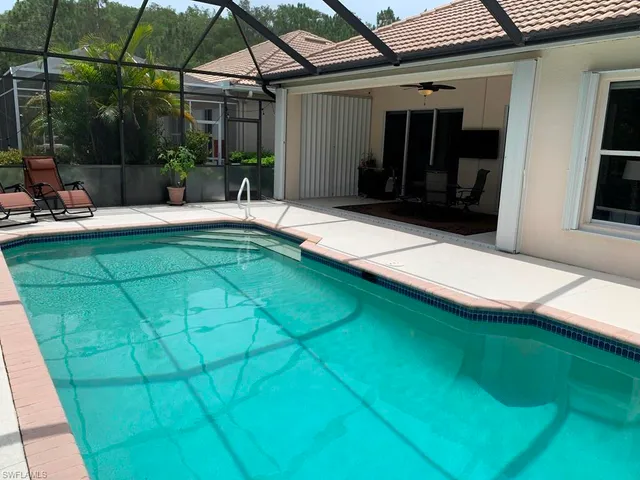 a view of a white house with a swimming pool