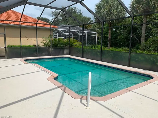 a view of a backyard with a small deck and a garden
