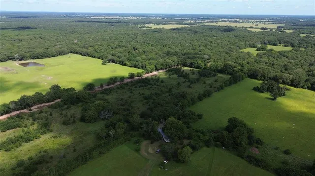 an aerial view of a houses with a yard