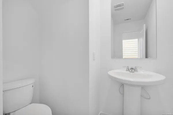 a bathroom with a sink a mirror and a toilet