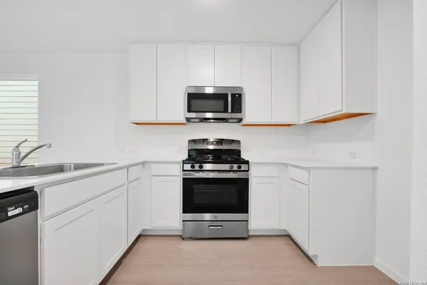 a kitchen with granite countertop a stove and a sink
