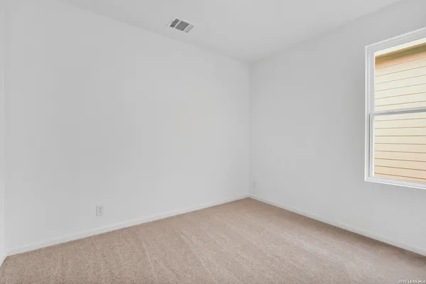 a view of an empty room and a window