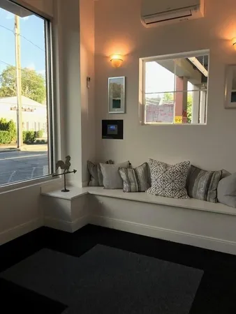 a living room with furniture and large window