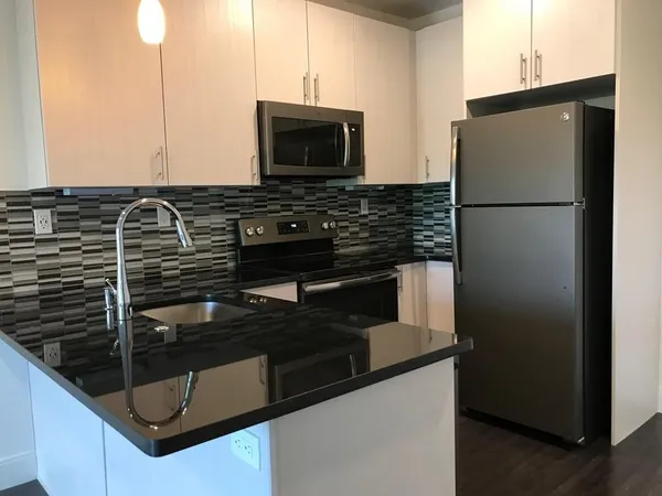 a kitchen with a refrigerator and a microwave