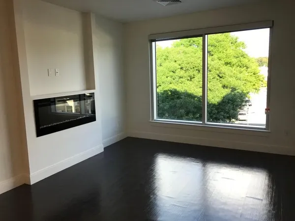 a view of a livingroom with furniture and a floor to ceiling window