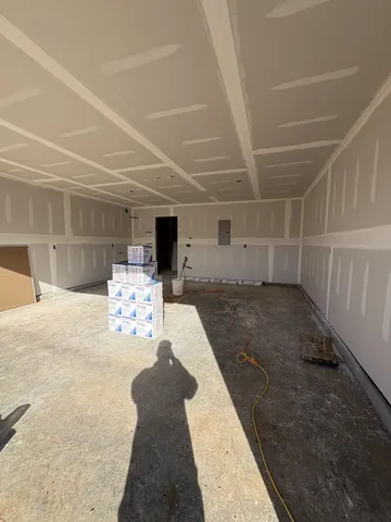 a room with furniture and view of kitchen