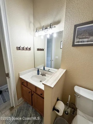 a bathroom with a sink a toilet and mirror