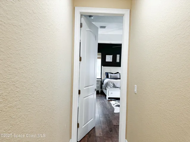 a view of a bedroom from a hallway