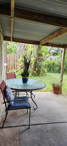 a view of a patio with table and chairs potted plants with wooden floor
