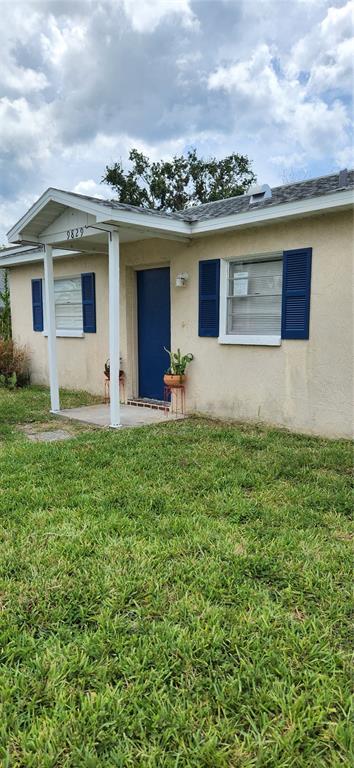 9829 Grace Drive Port Richey, FL 34668 - Photo 2 of 19 a front view of house with yard