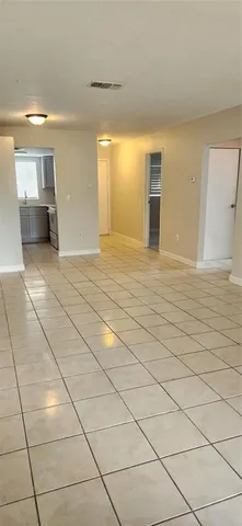 a view of an empty room and a window