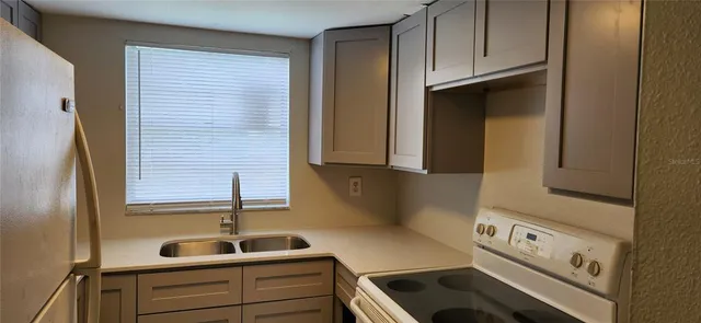 a kitchen with a sink and cabinets
