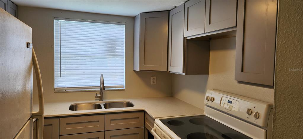 9829 Grace Drive Port Richey, FL 34668 - Photo 6 of 19 a kitchen with a sink and cabinets