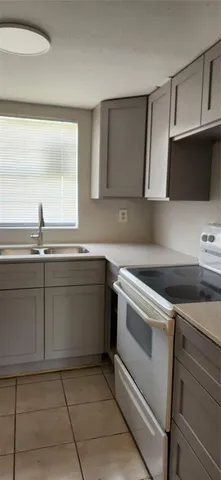 a kitchen with a sink and a stove top oven