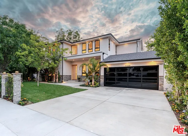 a view of house with outdoor space and parking