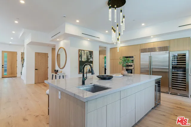 a view of a kitchen counter space a sink and appliances