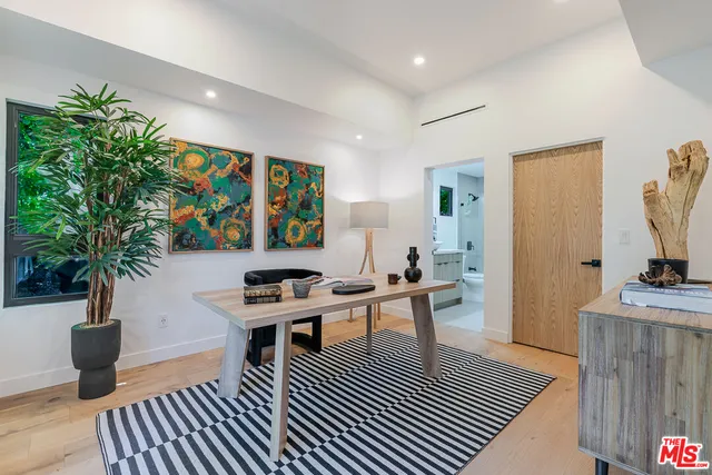 a living room with furniture a potted plant and a fireplace
