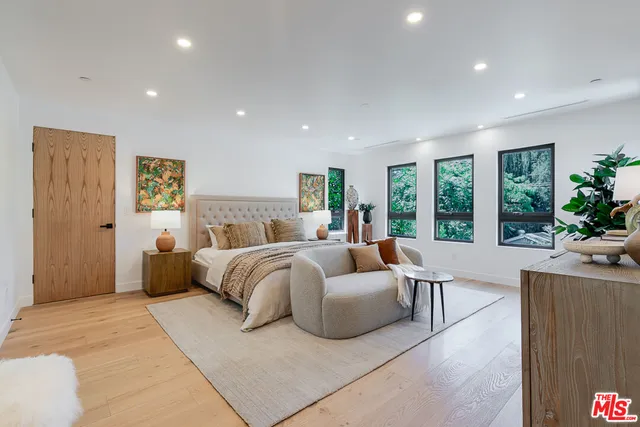 a bedroom with a large bed and a couch