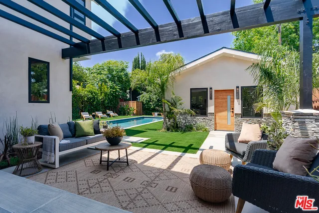 a outdoor living space with furniture potted plant and a fireplace