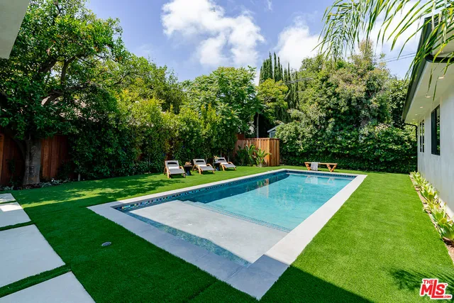 a view of a backyard with a small pool