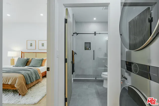 a bedroom with a bed and a mirror