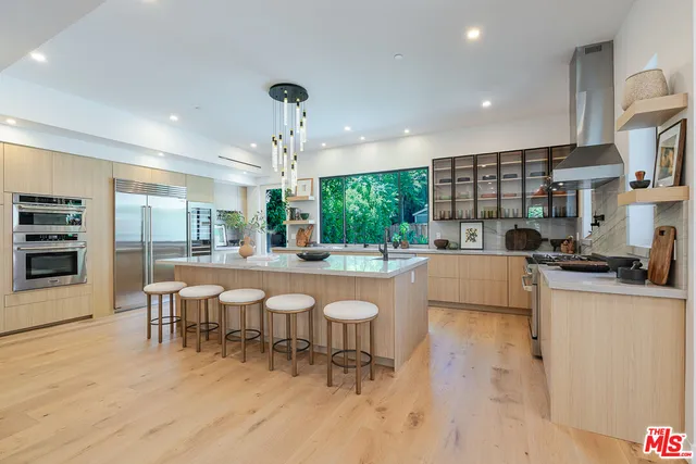 a large kitchen with a table and chairs