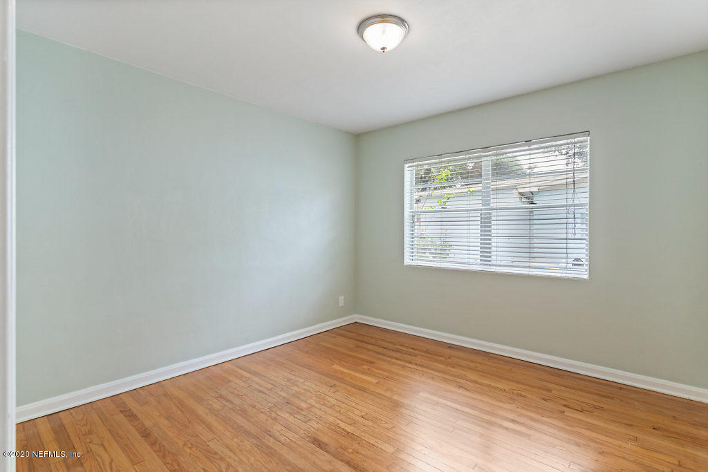 6303 Wesleyan Road Jacksonville, FL 32217 - Photo 39 of 50 an empty room with wooden floor and windows