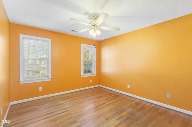 a bathroom with a granite countertop sink a toilet and a mirror
