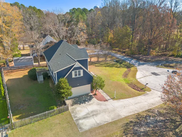 an aerial view of a house with a garden and swimming pool