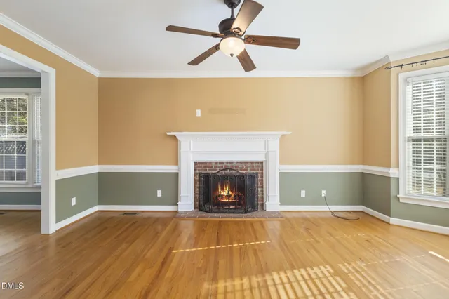 a view of an empty room with window and fire place