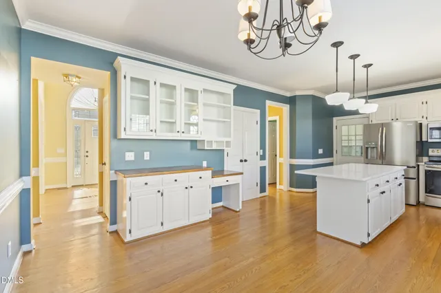 a large white kitchen with a large window