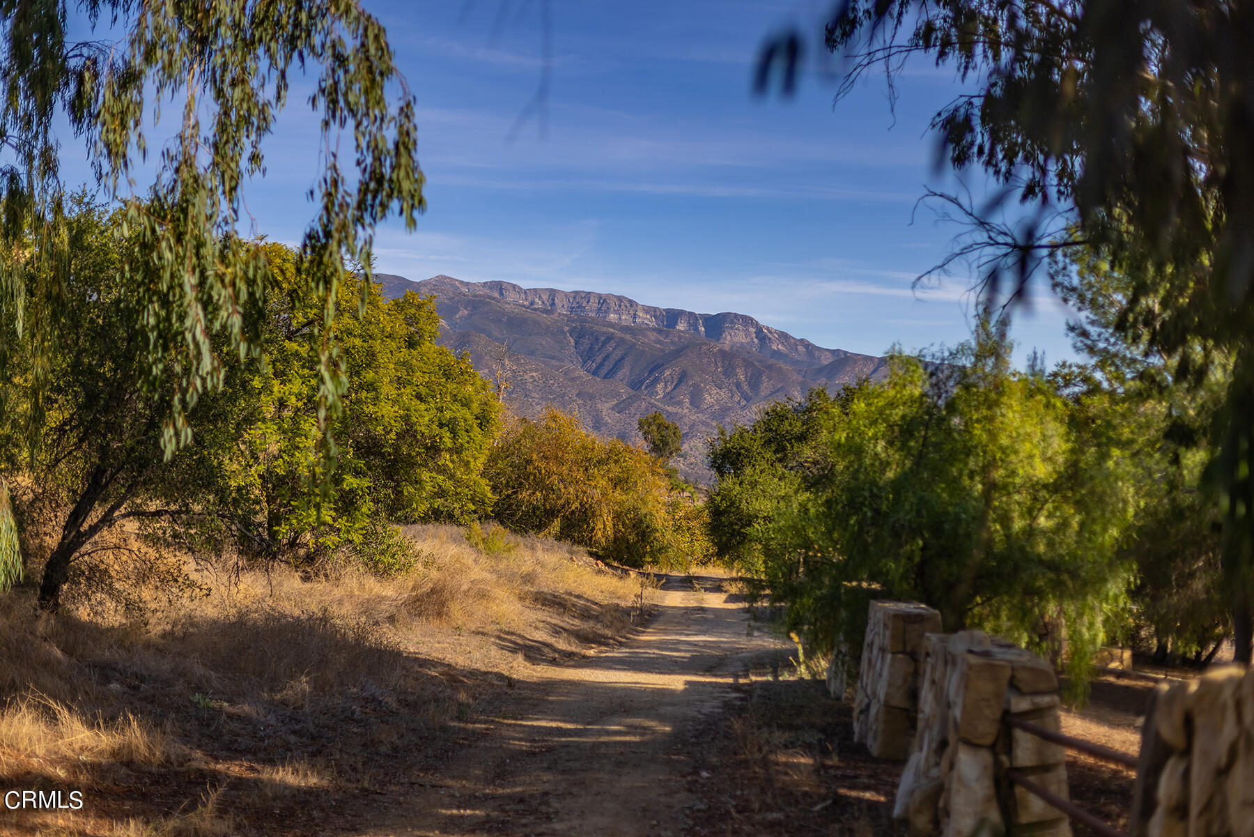 1218 Foothill Road Ojai, CA 93023 - Photo 17 of 30 a view of a yard with mountain and wooden fence