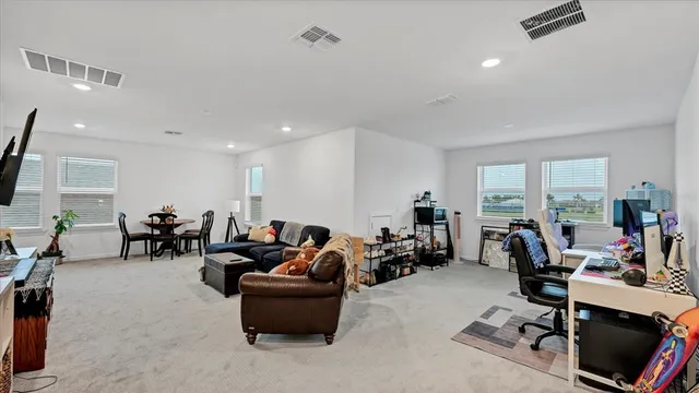 a bedroom with a bed and a flat tv screen on dresser