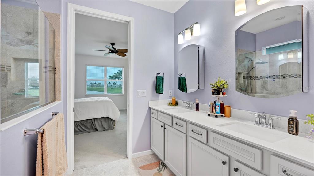 8705 Coastal Key Way Palmetto, FL 34221 - Photo 15 of 64 a en suite bathroom with double vanity sink and a mirror