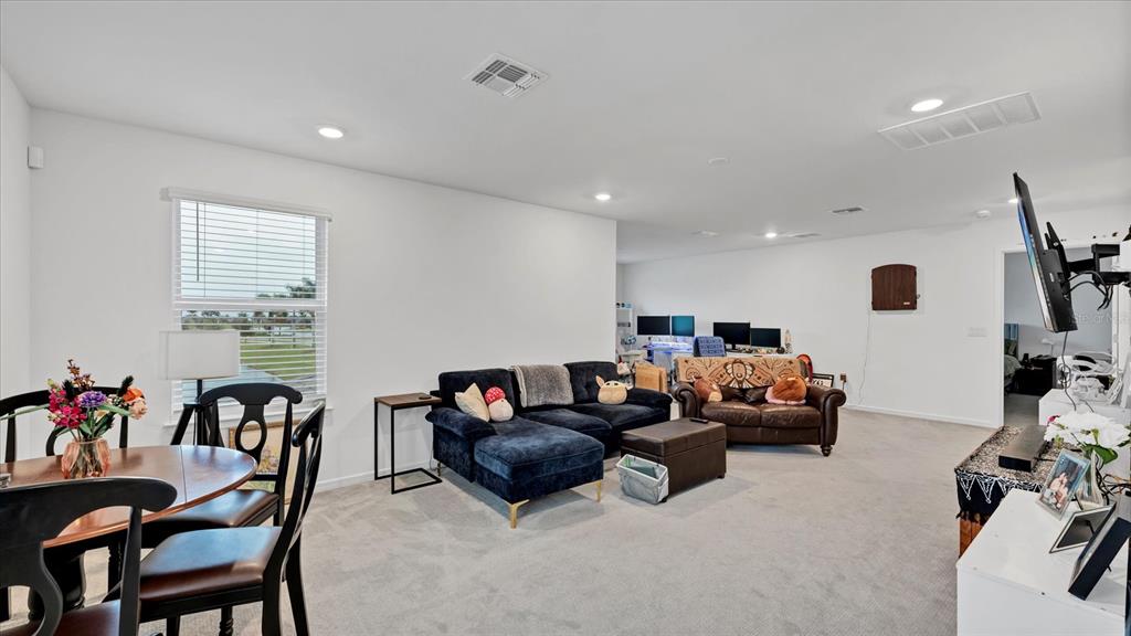 8705 Coastal Key Way Palmetto, FL 34221 - Photo 15 of 68 a living room with furniture and a flat screen tv