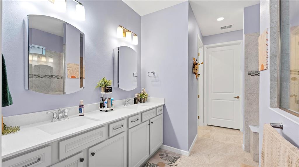 8705 Coastal Key Way Palmetto, FL 34221 - Photo 16 of 64 a spacious bathroom with a double vanity sink mirror and next to a window