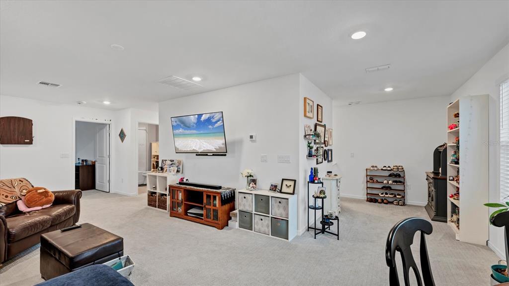8705 Coastal Key Way Palmetto, FL 34221 - Photo 19 of 68 a living room with furniture and a flat screen tv