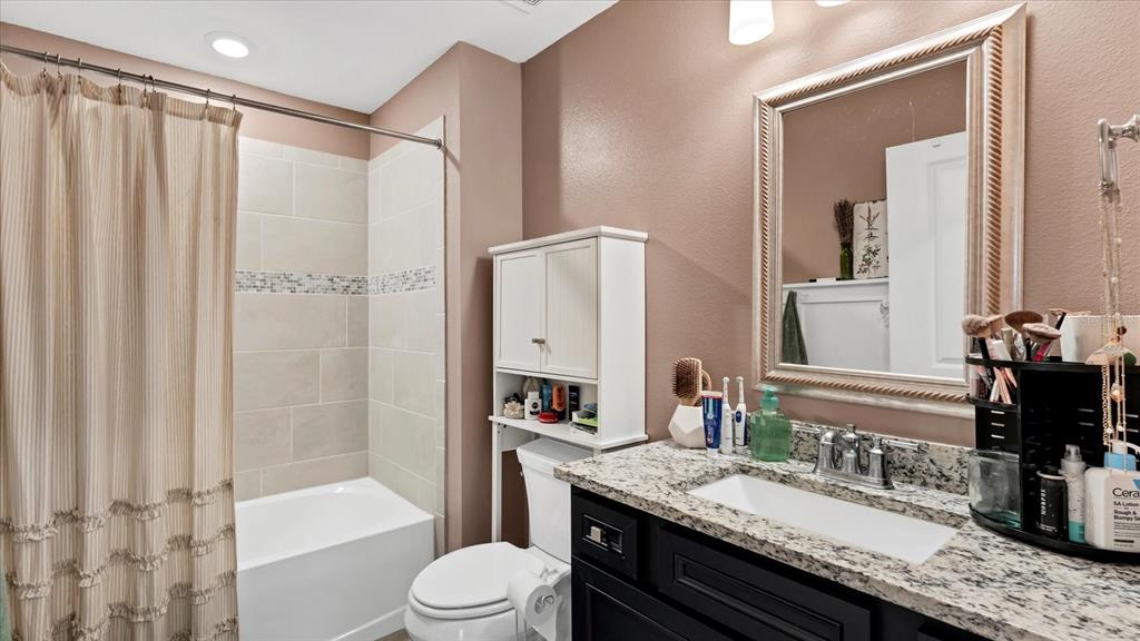 8705 Coastal Key Way Palmetto, FL 34221 - Photo 20 of 64 a bathroom with a granite countertop sink toilet and shower