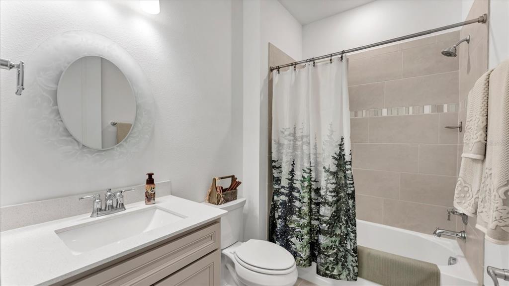 8705 Coastal Key Way Palmetto, FL 34221 - Photo 30 of 64 a bathroom with a sink a toilet and shower