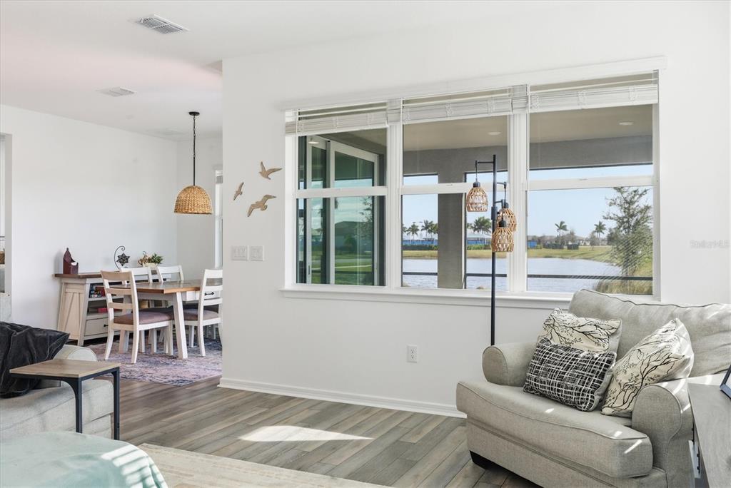 8705 Coastal Key Way Palmetto, FL 34221 - Photo 3 of 68 a living room with furniture wooden floor and a large window