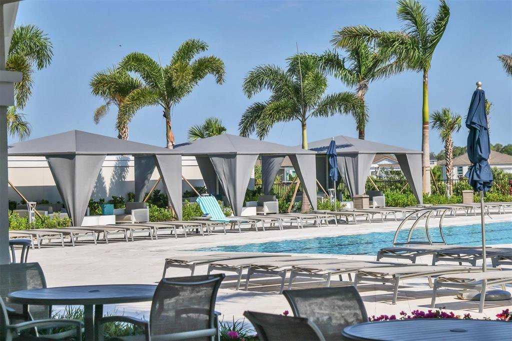 8705 Coastal Key Way Palmetto, FL 34221 - Photo 54 of 64 a view of a patio with a table and chairs and potted plants