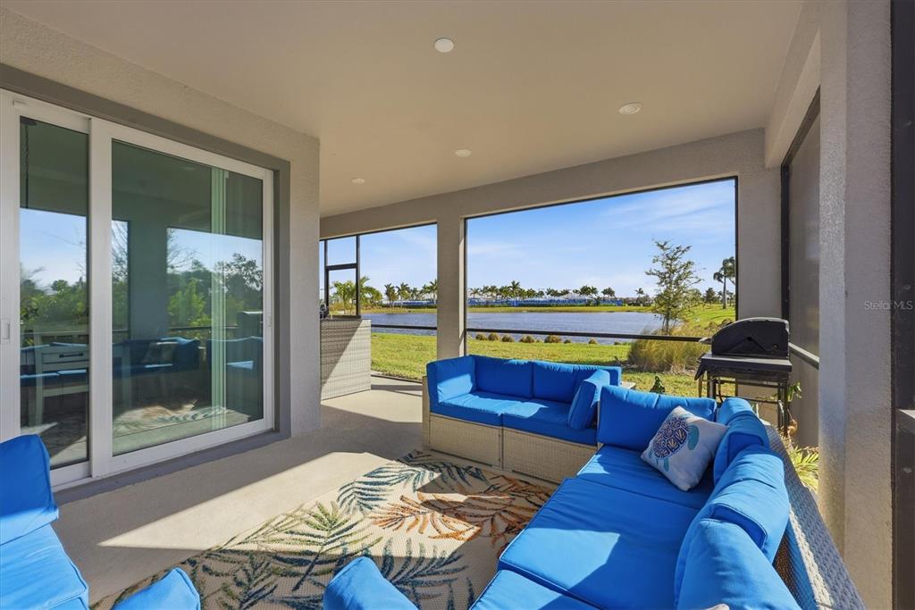8705 Coastal Key Way Palmetto, FL 34221 - Photo 6 of 68 a living room with furniture and a floor to ceiling window