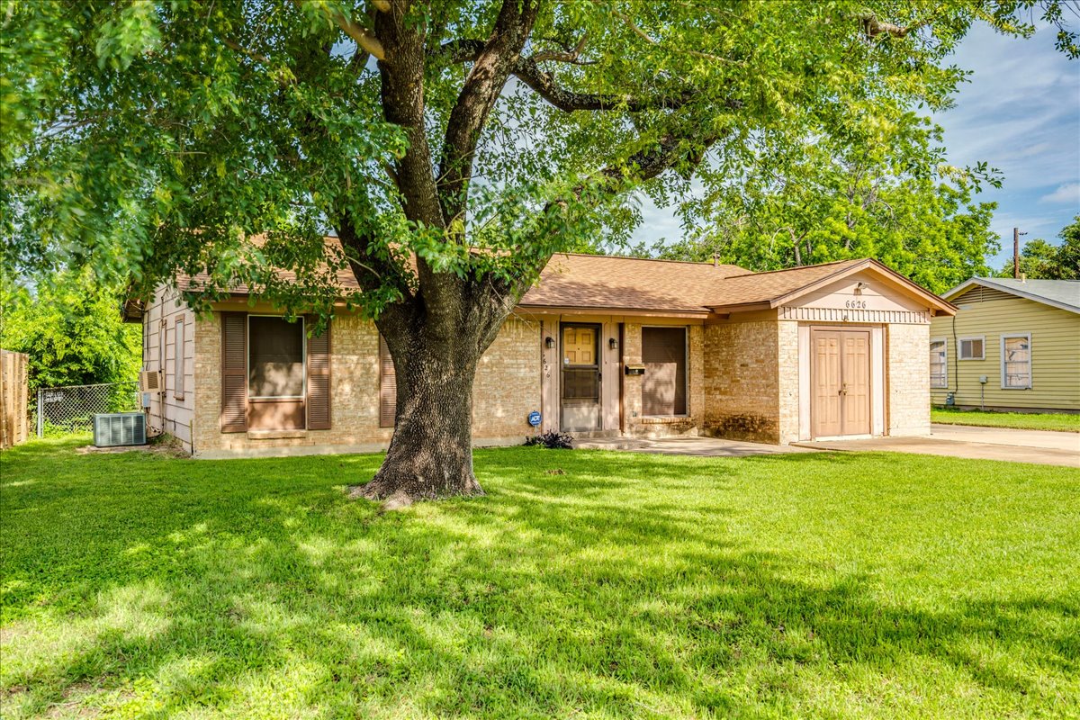6626 Isabelle Drive Austin, TX 78752 - Photo 3 of 27 Single-story brick residence with a mature front yard tree