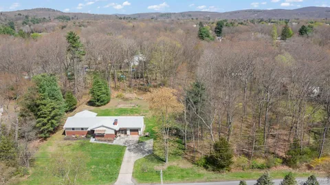 an aerial view of a house with a yard