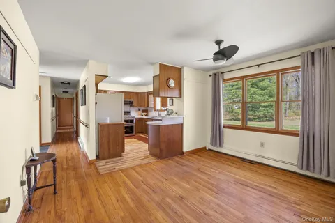 a view of kitchen with livingroom and wooden floor