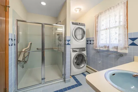a view of a bathroom with a sink a washer and dryer