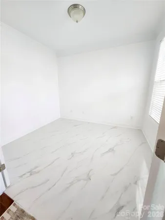 a view of a room with wooden floor and staircase