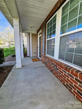 a view of a porch with wooden floor and fence