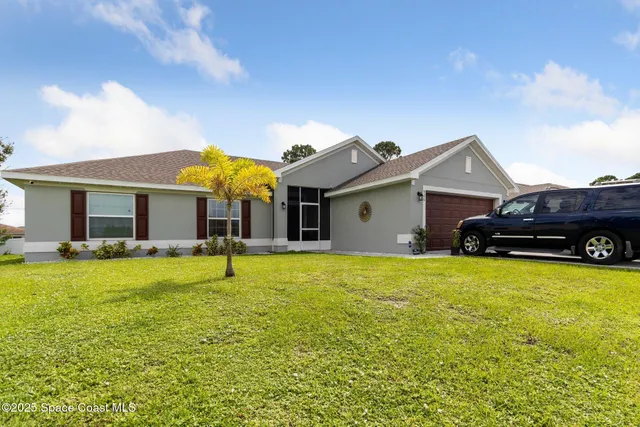 a view of a house with swimming pool and a yard